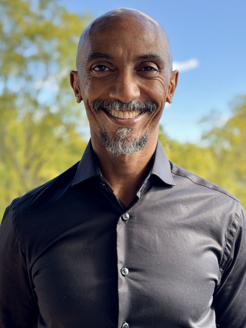 Yohannes Petros smiling, outdoors.